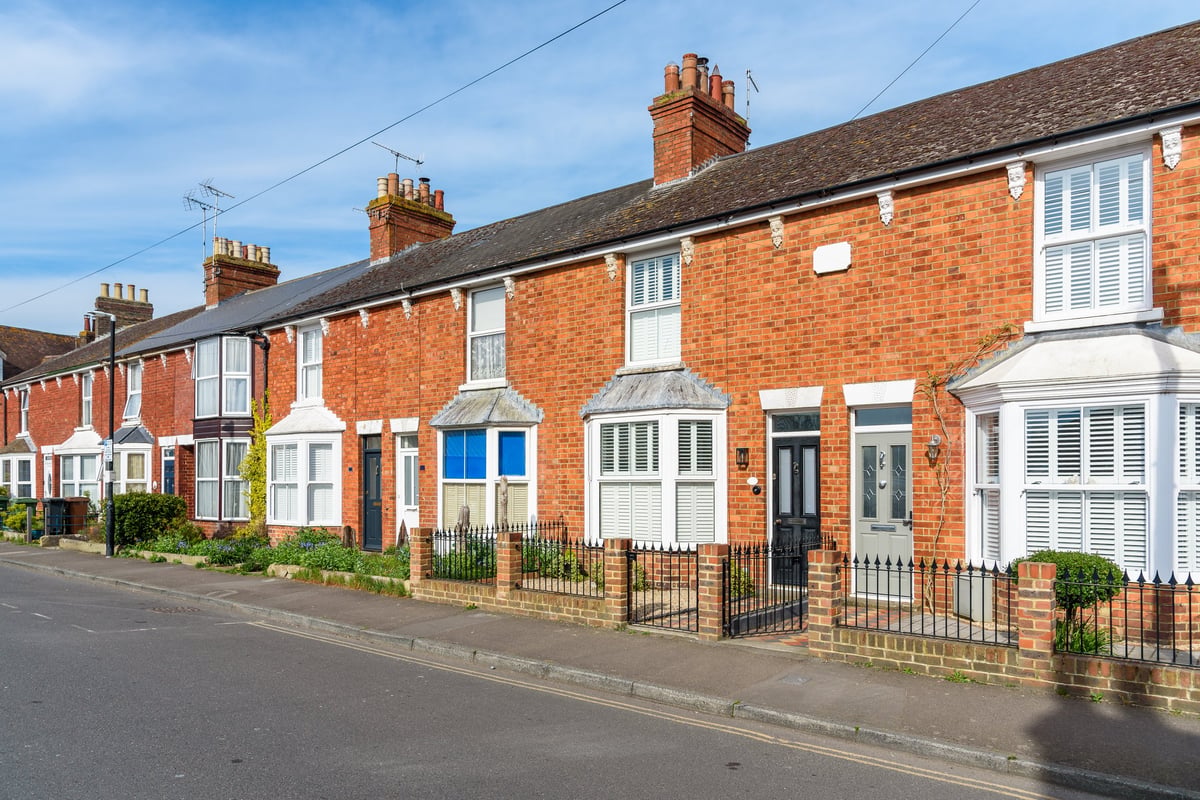 Old brick terraced houses with bay windows on a sunny day in England